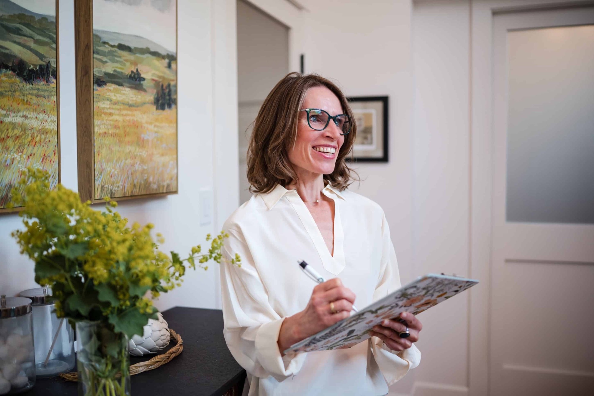Dr. Olivia Franks smiling with a clipboard in her office