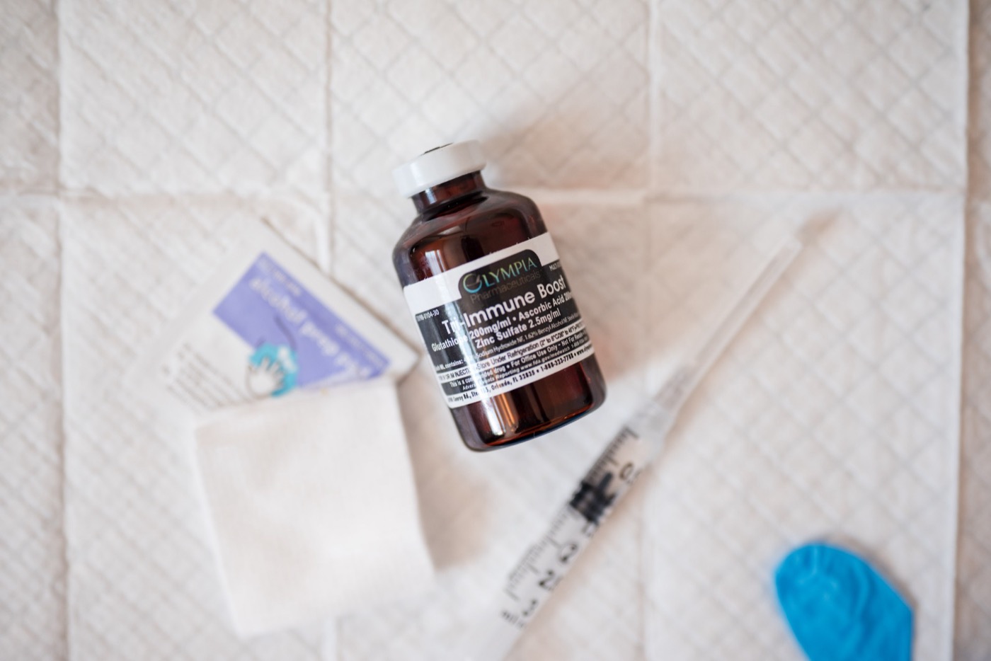 A vial of Tri-Immune Boost with glutathione, vitamin C and zinc, ready for a nutrient shot