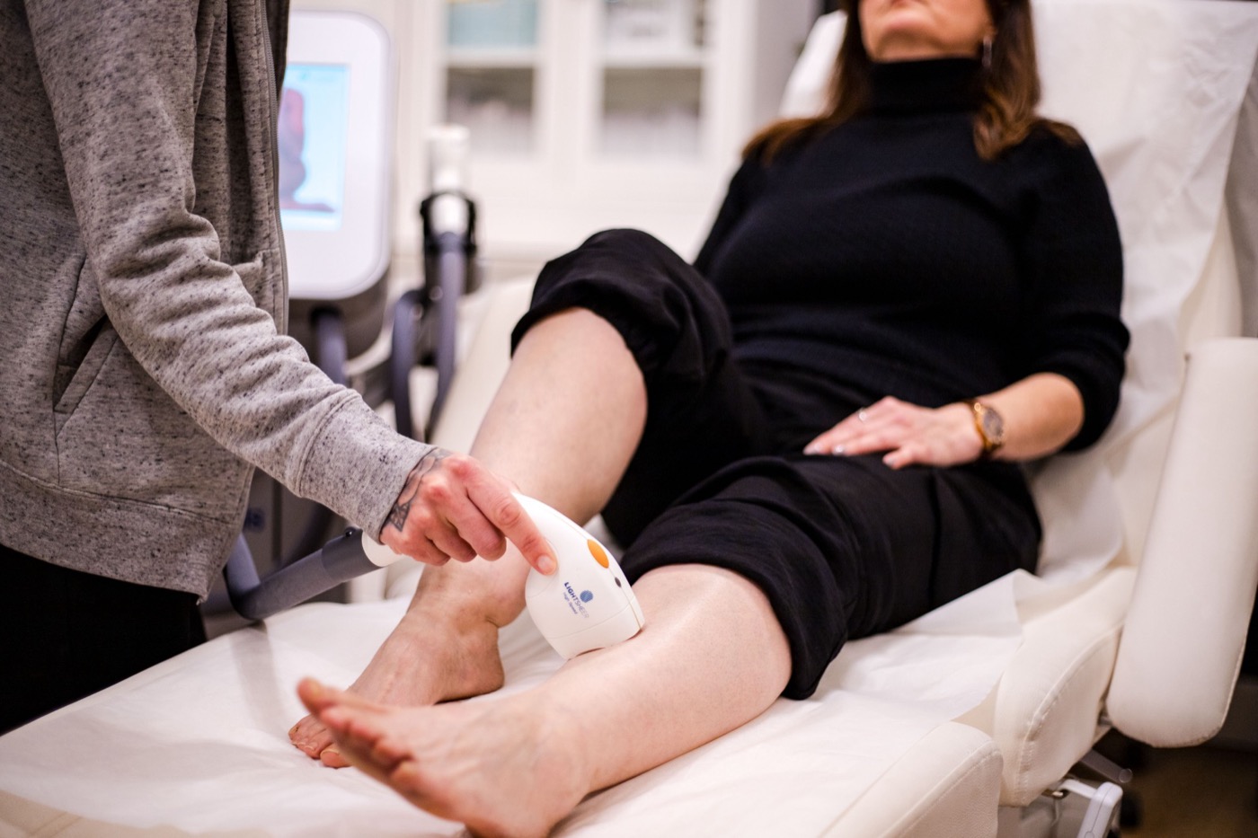 The LightSheer laser on a patient&rsquo;s ankle as she relaxes in the treatment chair